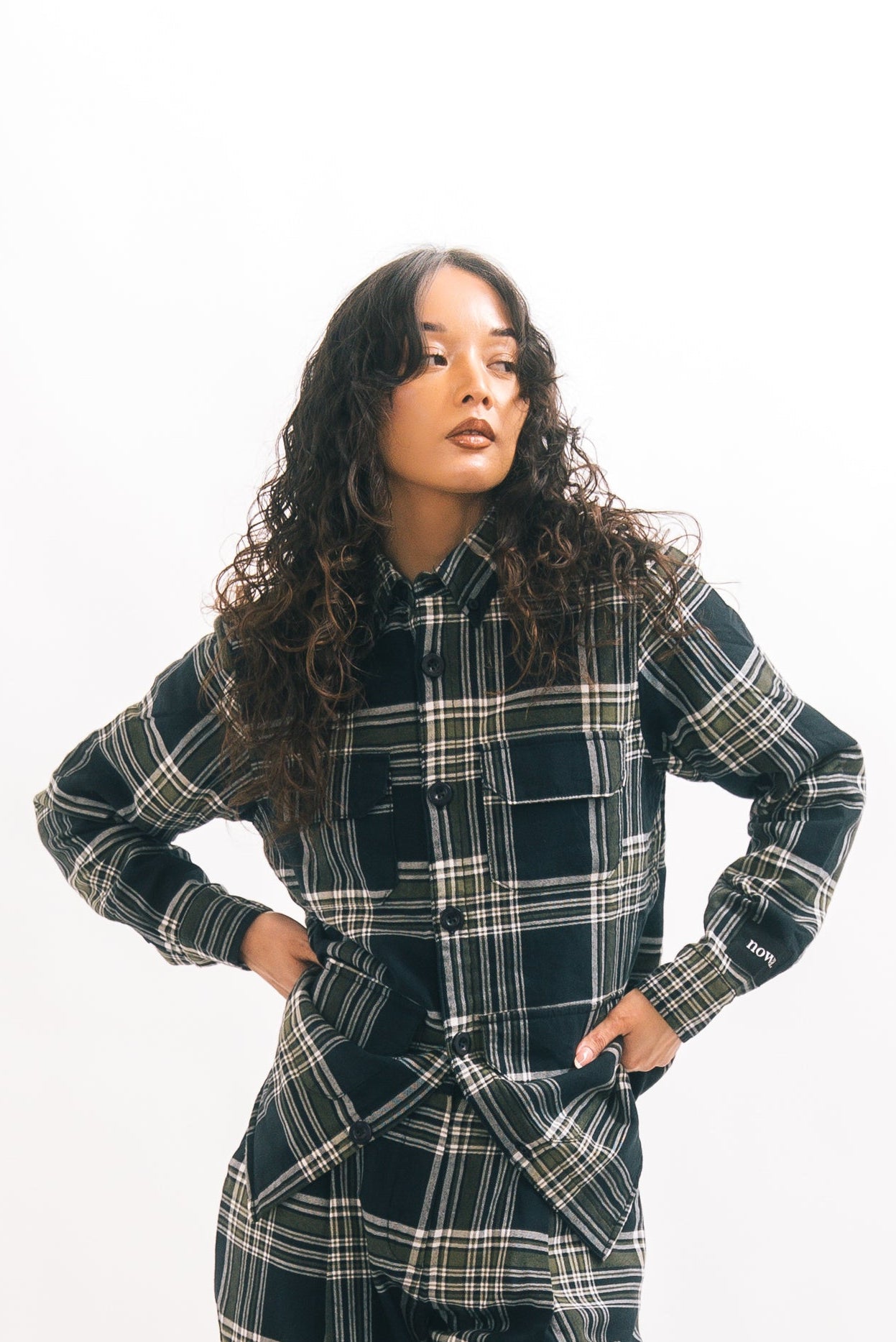 Woman wearing a plaid outfit on a white background